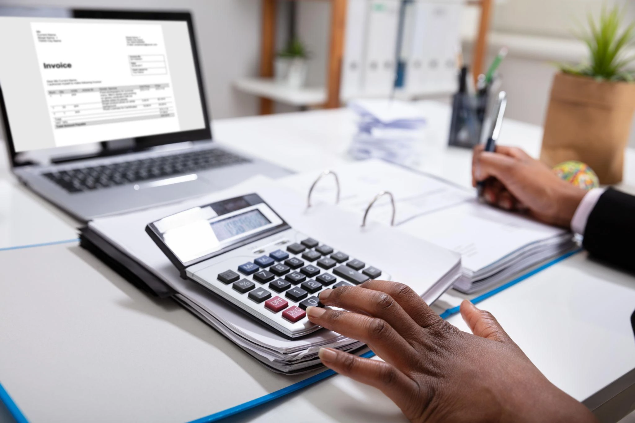 Business tax preparation services with accountant calculating financial data and reviewing reports.