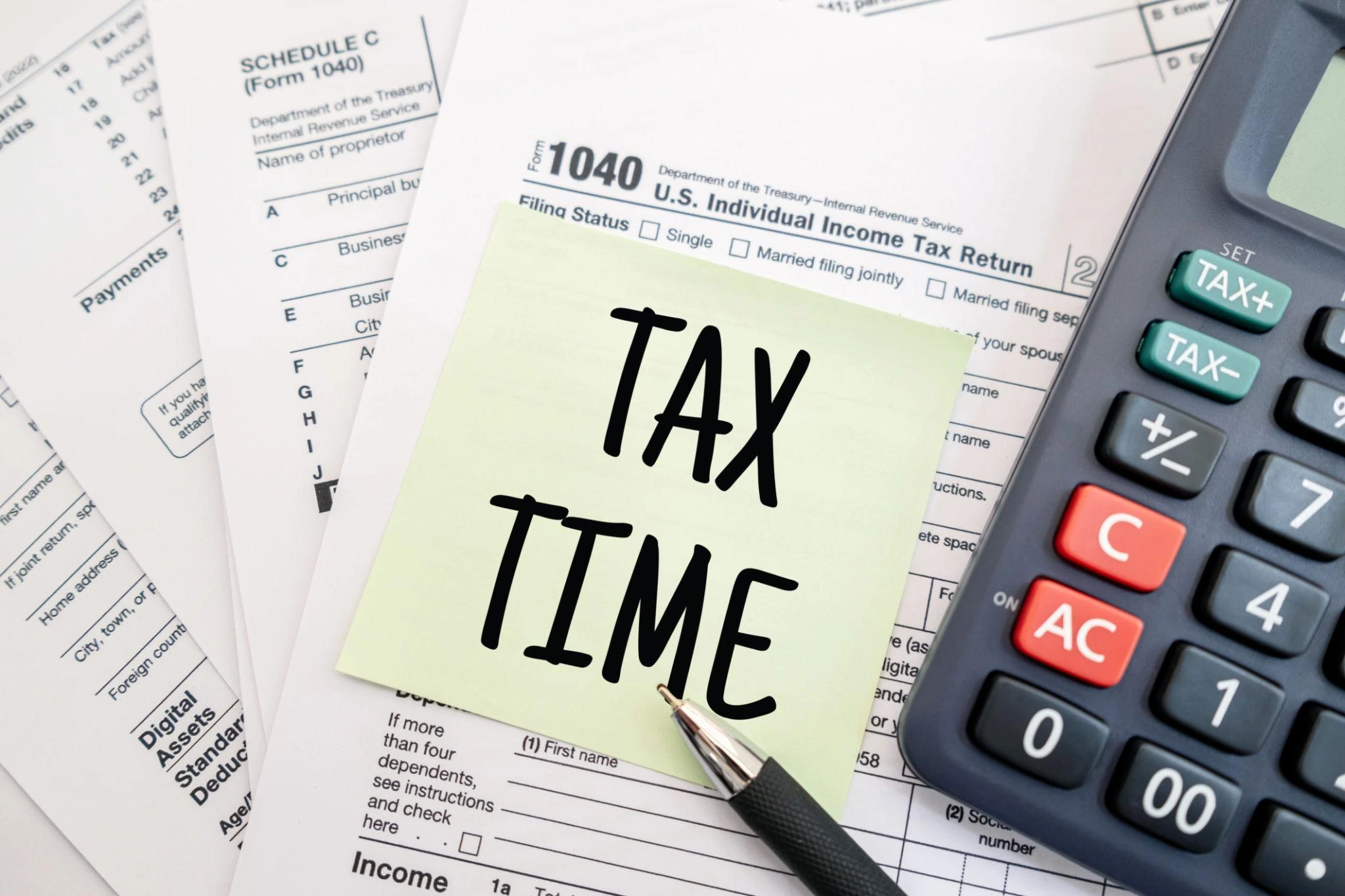 Tax preparation services USA with 1040 form, calculator, and tax documents on desk.