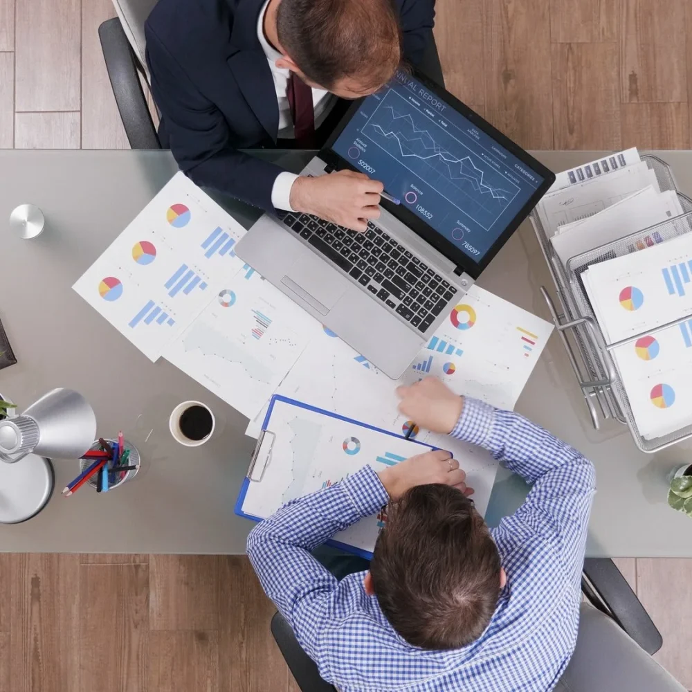 top-view-of-businessmen-analyzing-management-statistics-while-working-at-company-bookkeeping-Services
